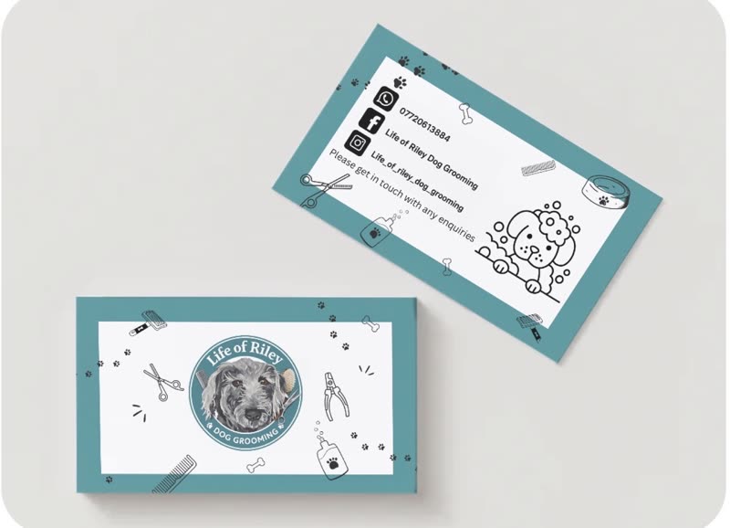 Life of Riley Dog Grooming business cards on a pale grey surface